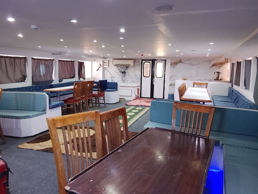 The air-conditioned saloon on board, set for meals and briefings