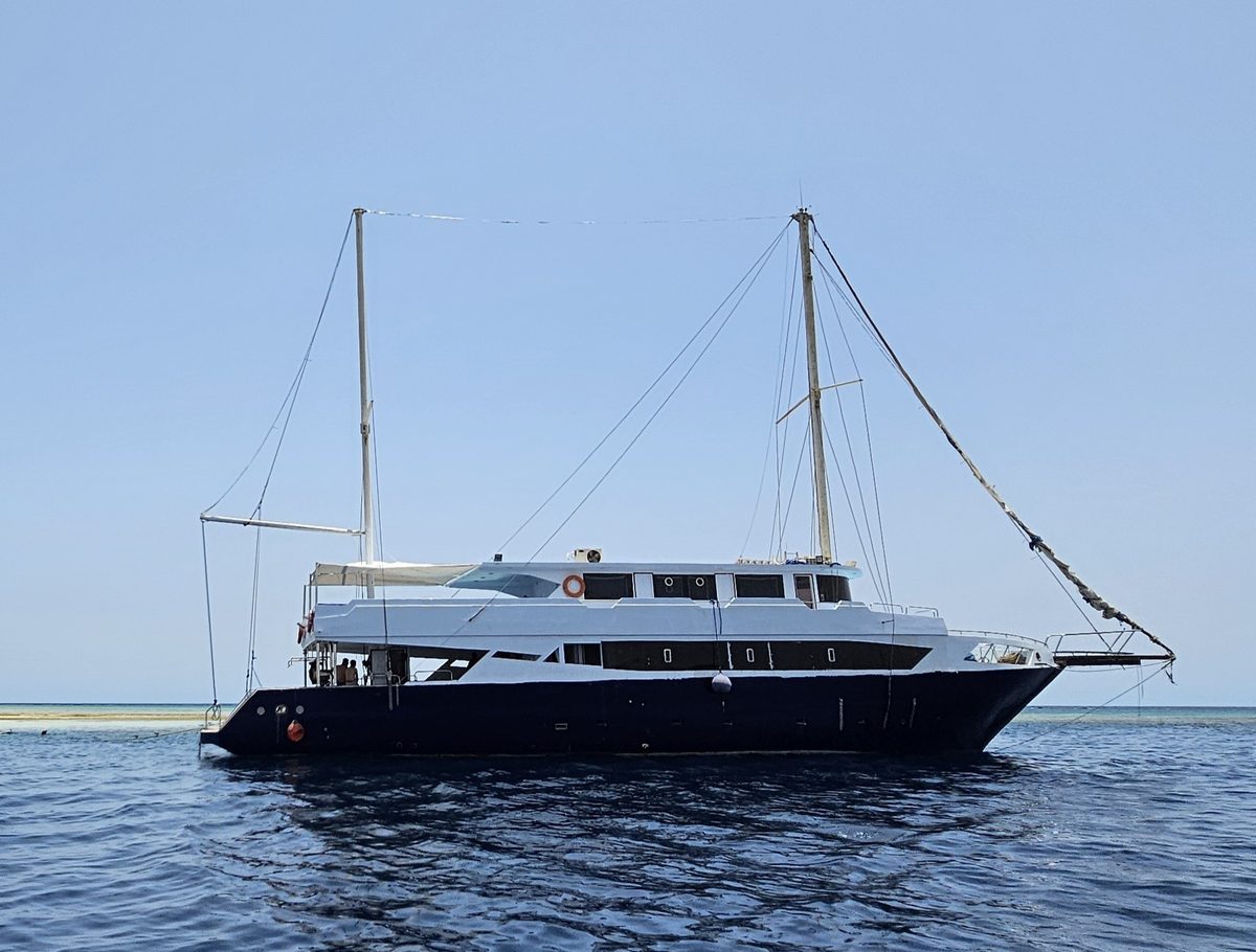 The Aquatic Divers boat at anchor beside a Red Sea reef