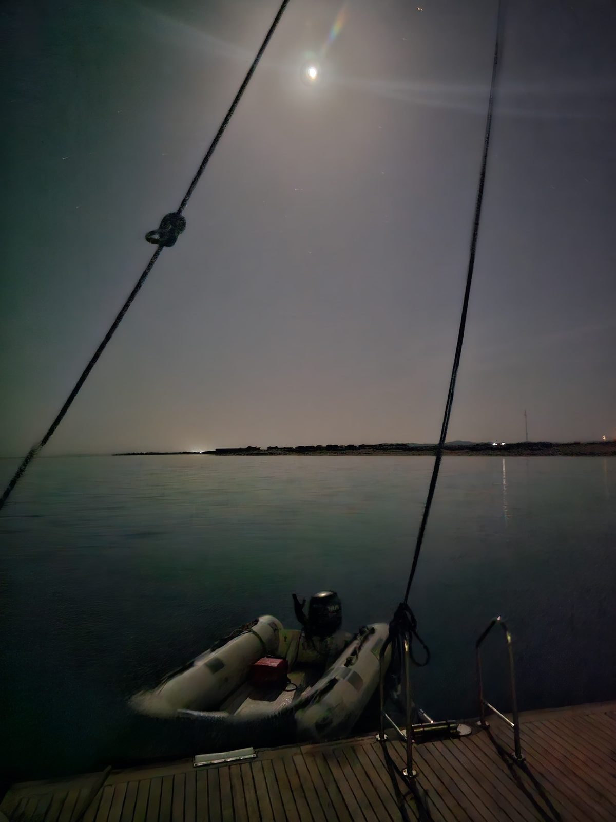 Moonlit night anchorage at Sataya with the zodiac tied alongside