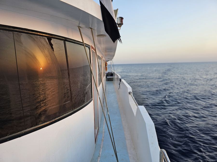 The side deck of the dive boat under way at sunset on the Red Sea