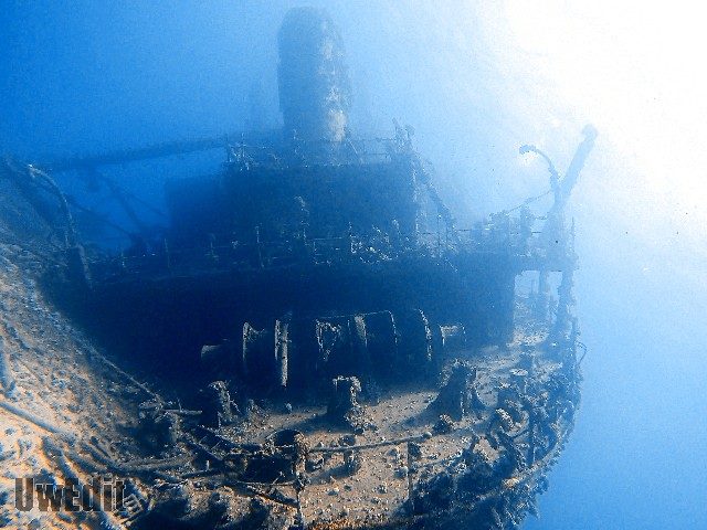 Sunken shipwreck covered in coral growth